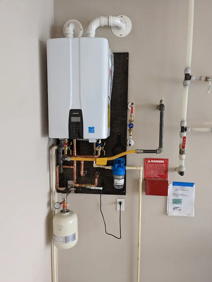 Professional plumber installing copper piping in a Wantage home